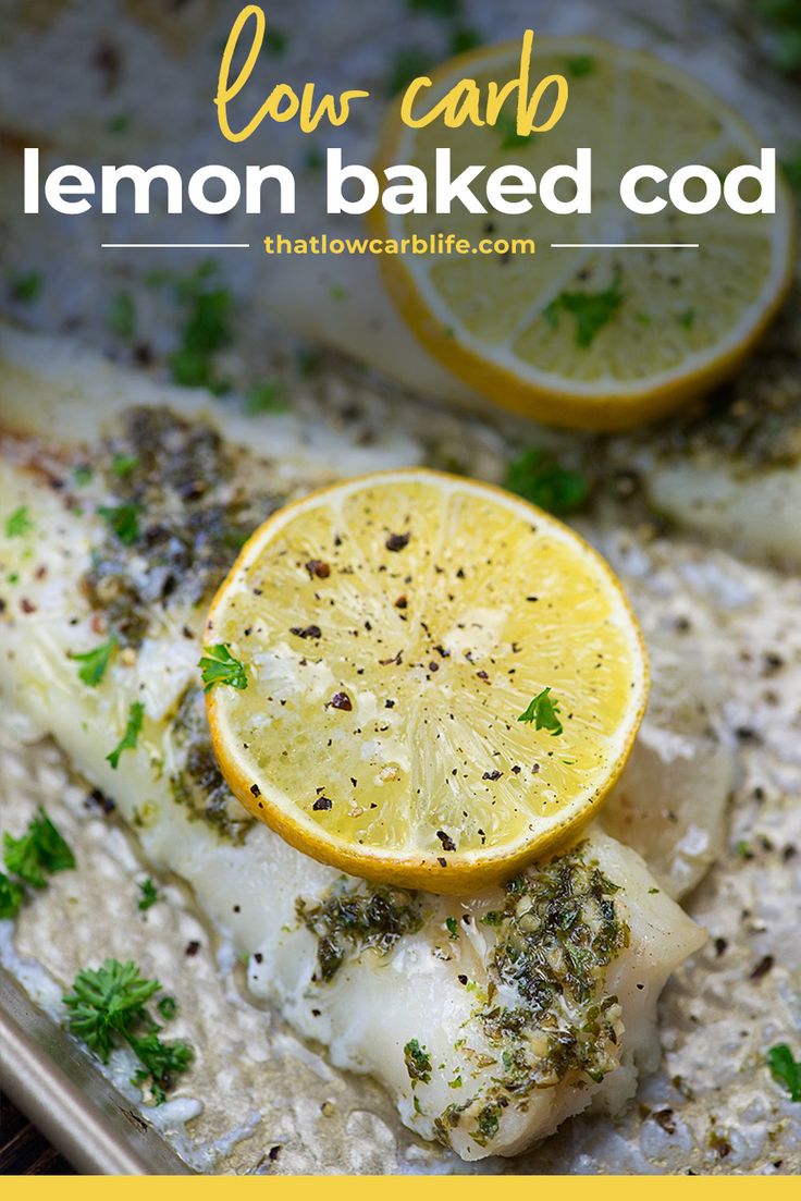 fish with lemon slices and parsley on top of it in a baking pan, ready to be cooked