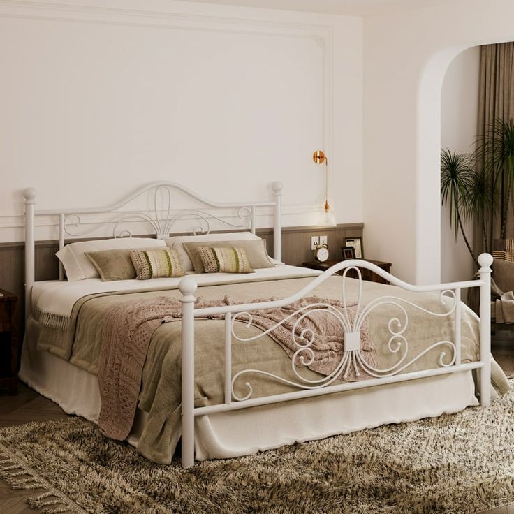 a bedroom with a white bed and rugs