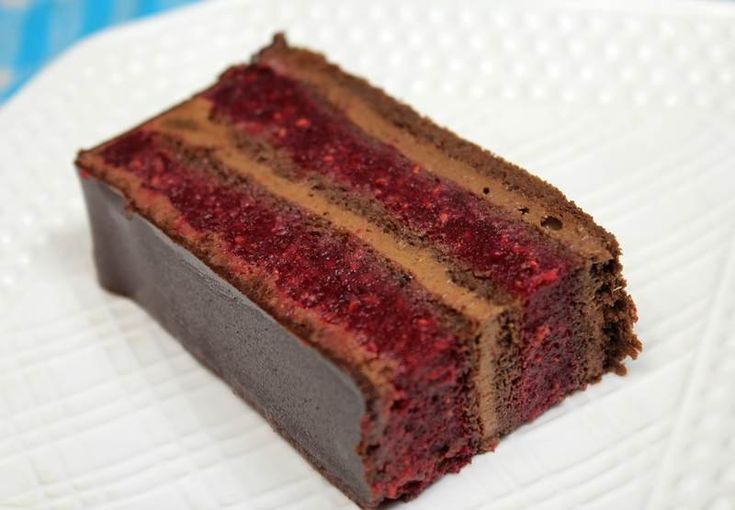 a piece of chocolate cake sitting on top of a white plate