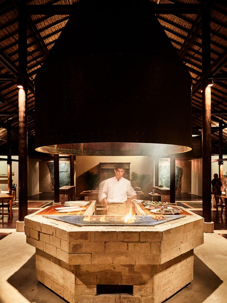 a man standing in front of a fire pit