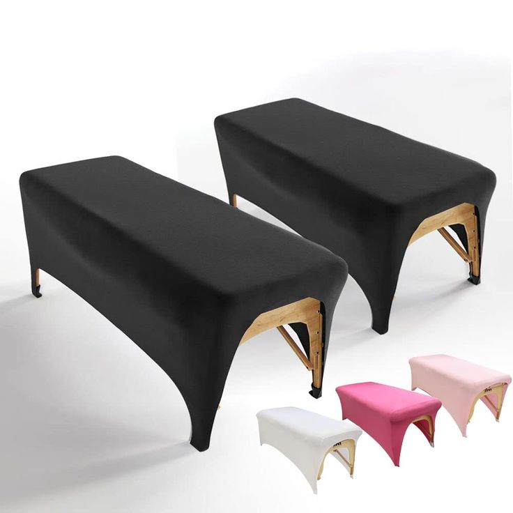 two black benches sitting next to each other on top of a white floor with wooden legs