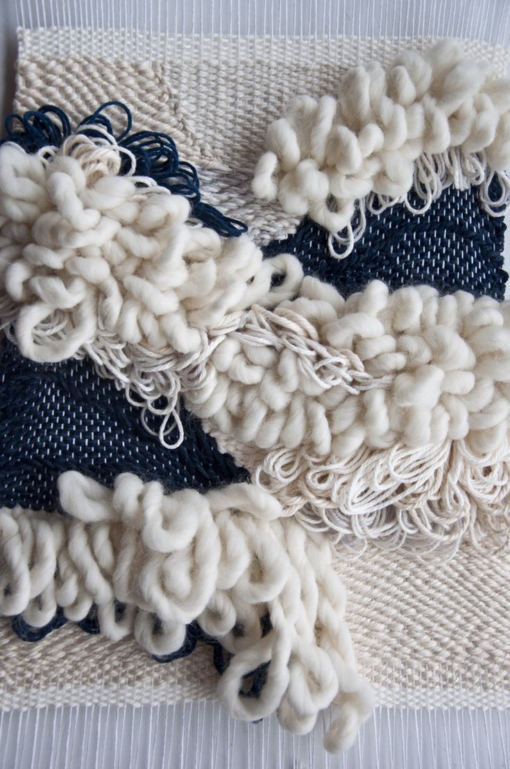 two pieces of fabric with white and blue yarn