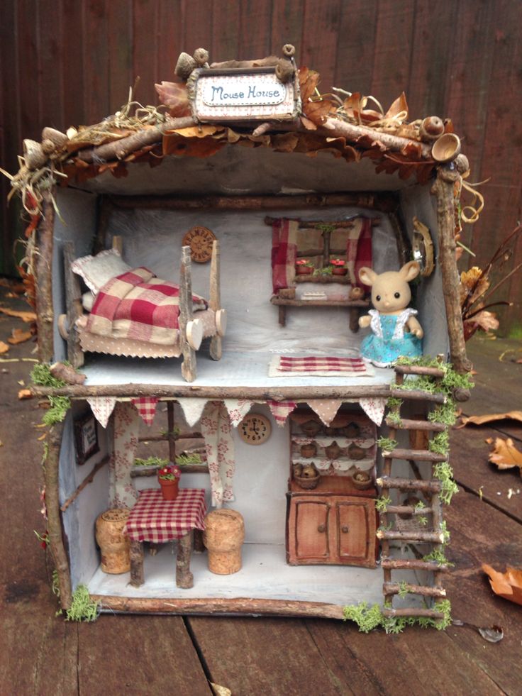 a doll house made out of wood with furniture