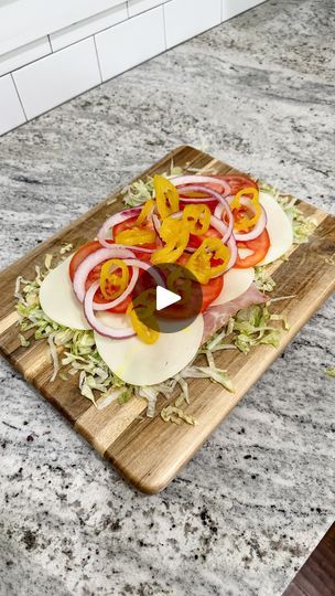 a cutting board topped with sliced vegetables on top of a counter