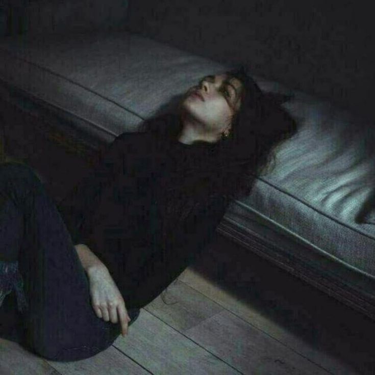 a woman laying on the floor with her eyes closed