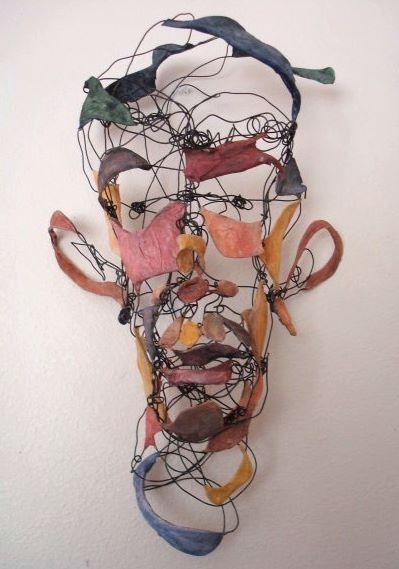 a sculpture made out of wire with birds perched on it's head and wires attached to the face