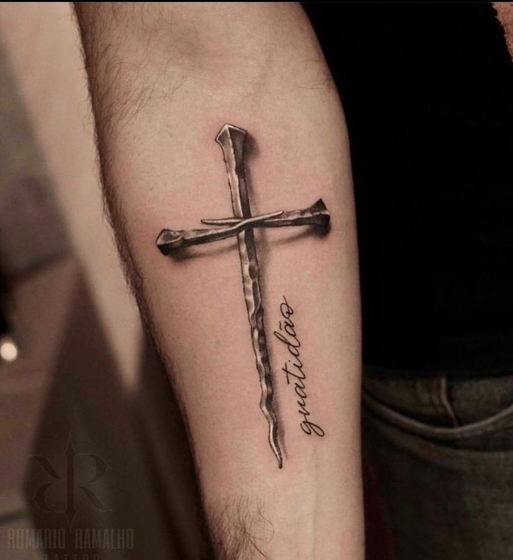 a man with a cross tattoo on his arm