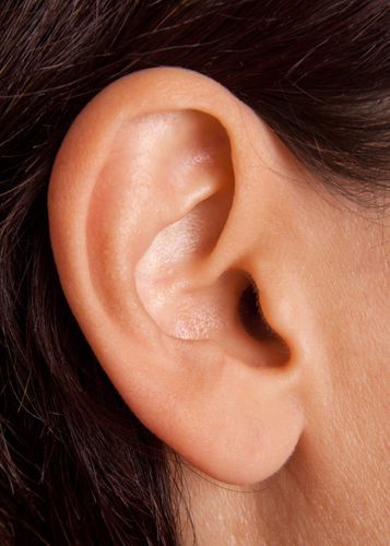 a woman's left ear is shown with the end of her ear in view