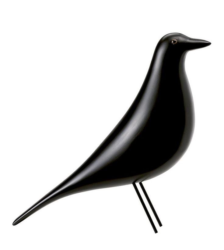 a black bird sitting on top of a wooden stand