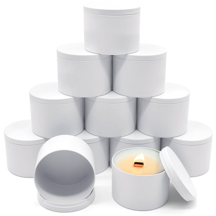 a stack of white boxes with a lit candle in the middle surrounded by smaller ones