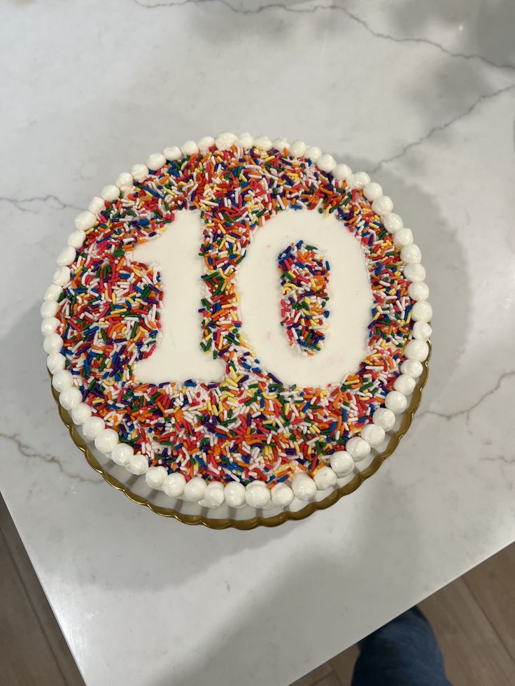 a birthday cake with sprinkles and the number 50 on it