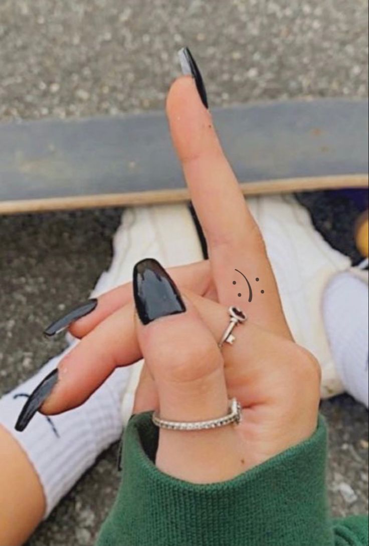 a person holding up their finger and pointing to the sky with two fingers on it