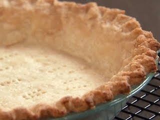 an uncooked pie sitting on top of a cooling rack