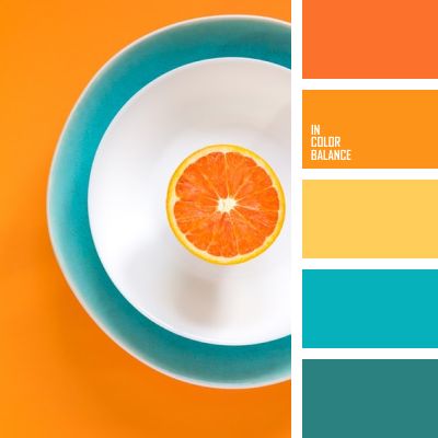 an orange slice on a plate with color swatches