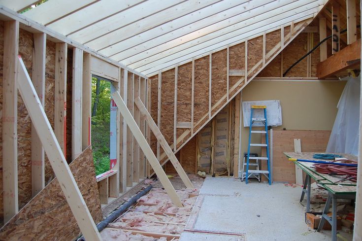 the inside of a house being built with wood framing on the walls and ceiling,