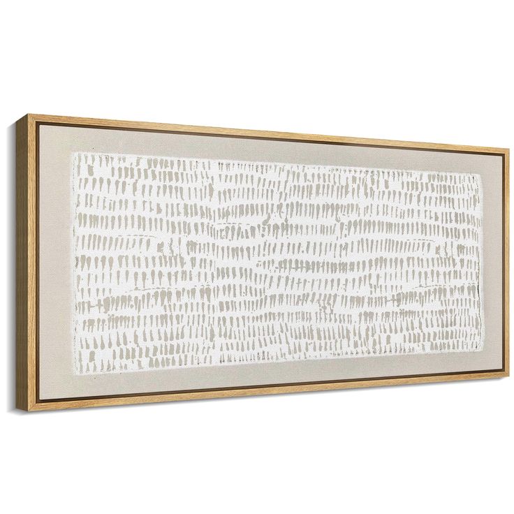 a white and gold framed wall hanging on the side of a wall with an abstract pattern