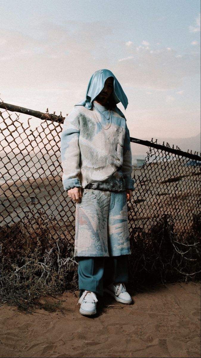 a person standing in front of a fence