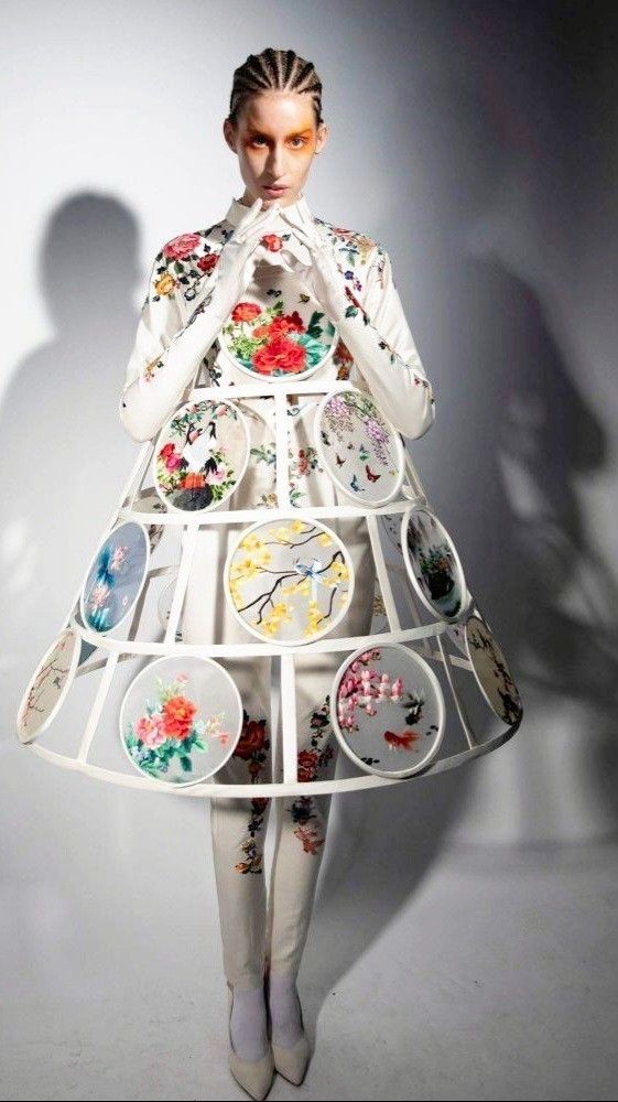 a woman in a dress made out of plates