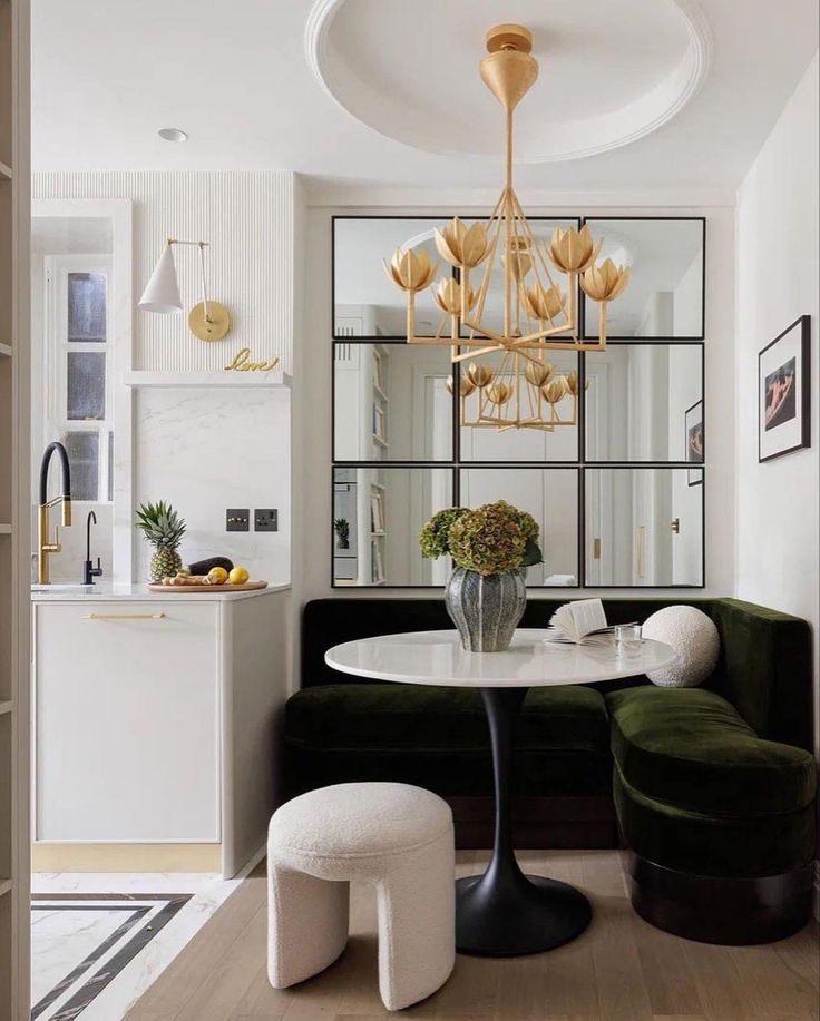 a living room with a couch, table and mirror in it's centerpiece