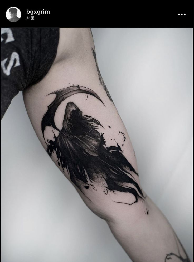 a man's arm with a black and white tattoo on it