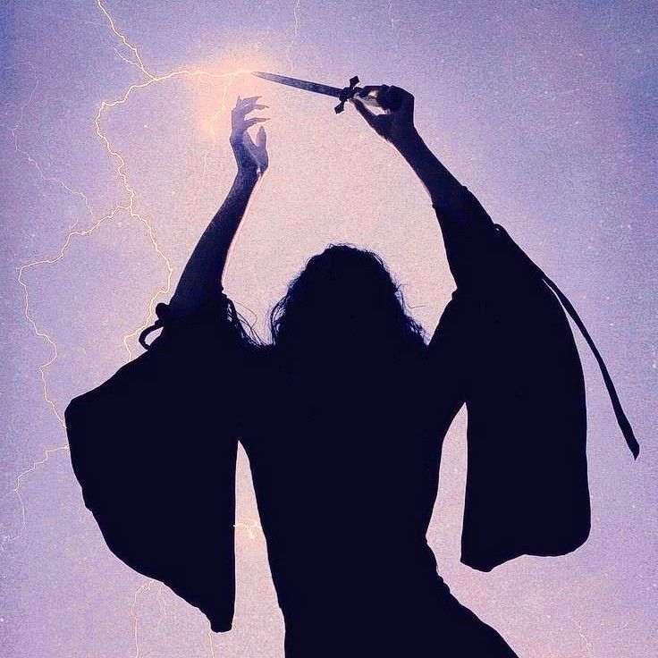 the silhouette of a woman holding a pair of scissors up to her head with lightning in the background