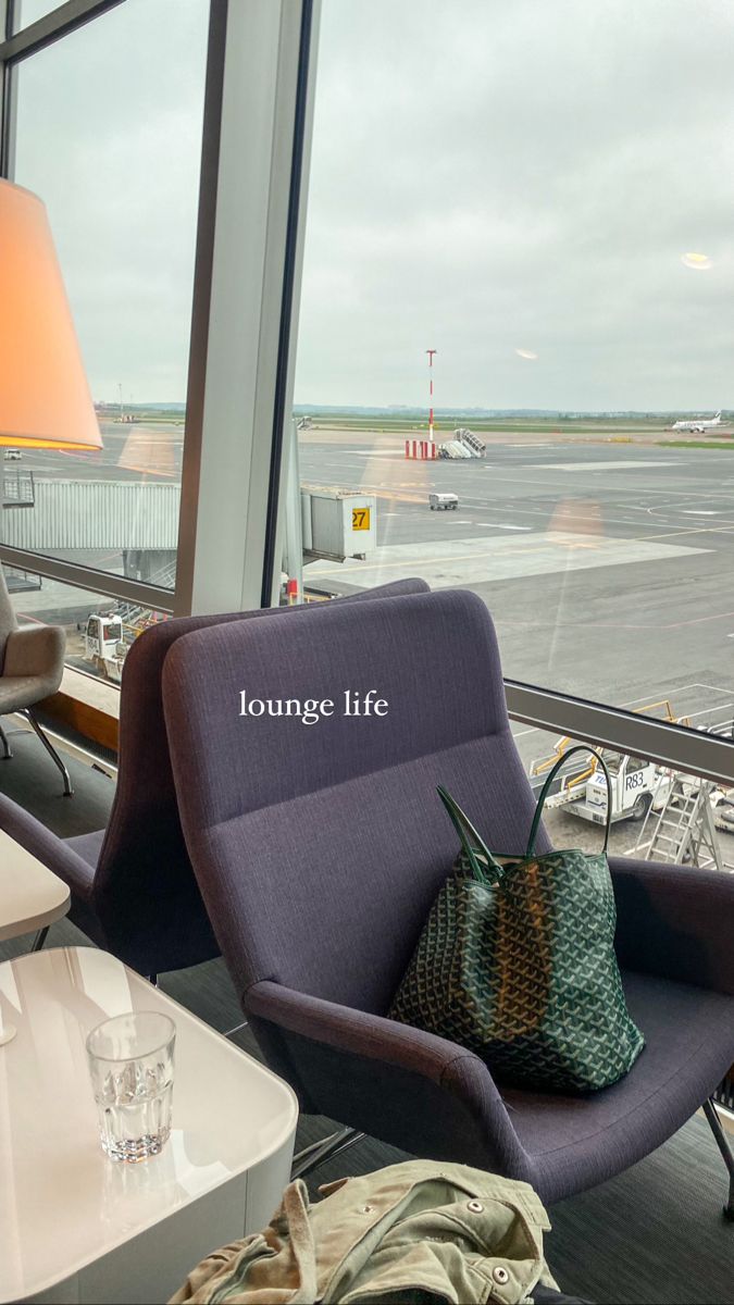 an airport lounge area with large windows looking out onto the tarmac