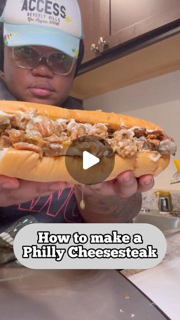 a man holding a large sandwich in his hands with the words how to make a phily cheese steak on it