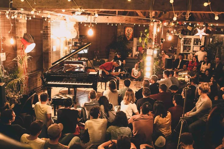 a group of people that are sitting in front of a piano