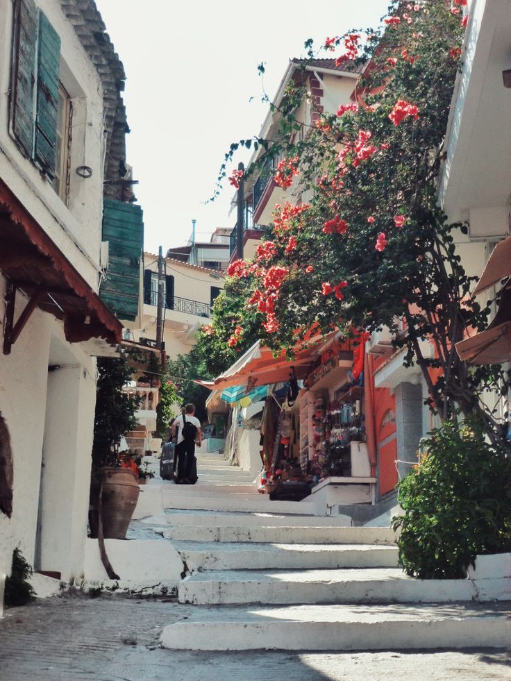 an alley way with flowers growing on it