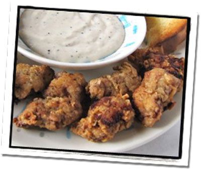 chicken wings with ranch dip on a white plate