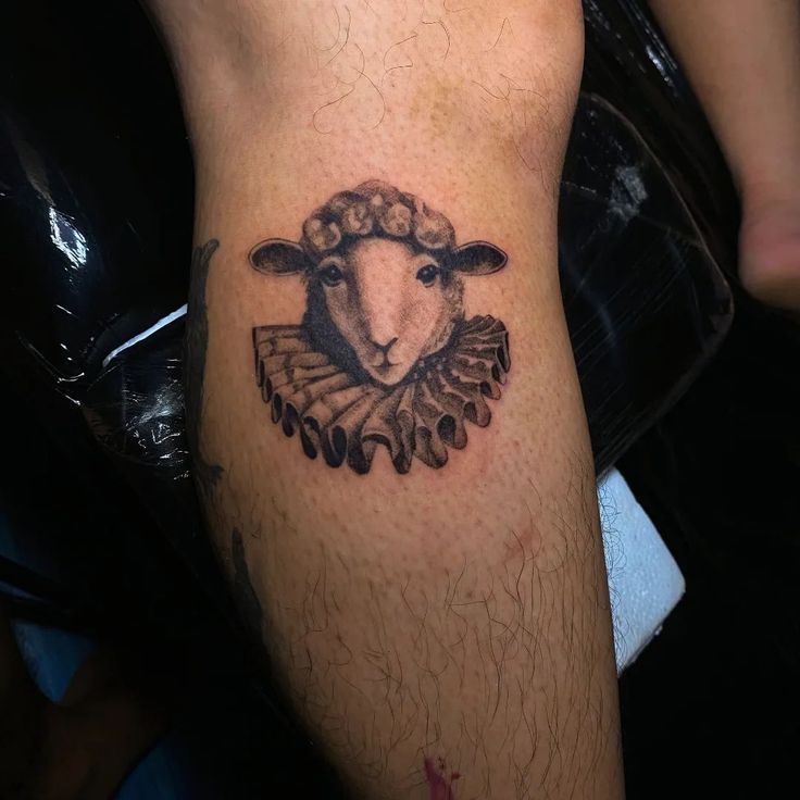 a sheep tattoo on the leg of a man