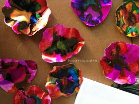 paper plates with colorful designs on them sitting next to a white piece of paper towel