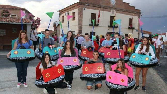 a group of young people holding up colorfully decorated items in front of a building