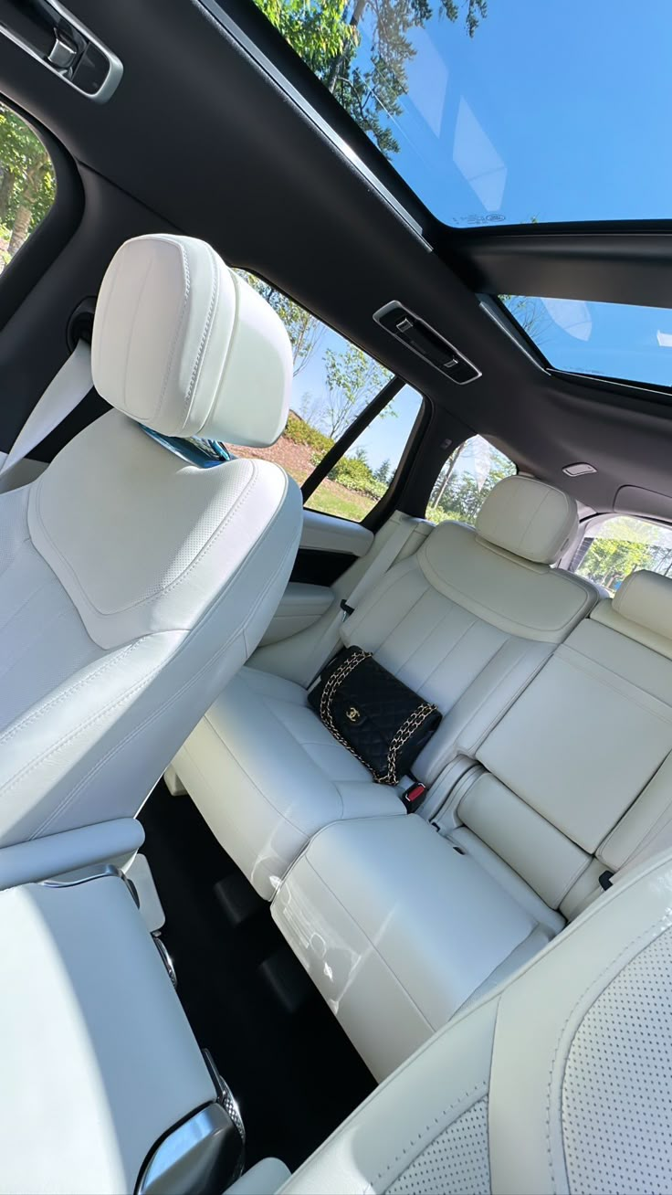 the interior of a car with white leather seats