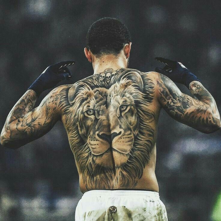 a man with tattoos on his back has a lion tattoo on his left arm and chest