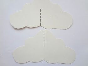 two pieces of paper cut out to look like clouds