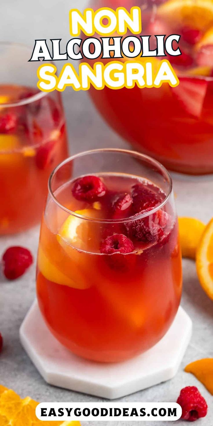 non alcoholic sangria with oranges and raspberries in the foreground text reads non alcoholic sangria