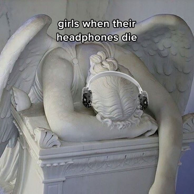 there is a statue with an angel holding a headphone in it's hand