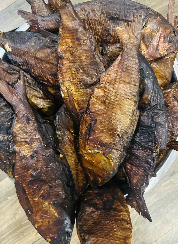 some fish are sitting in a bowl on the table and ready to be cooked for consumption