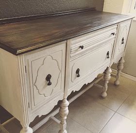 an old white dresser with wood top and drawers