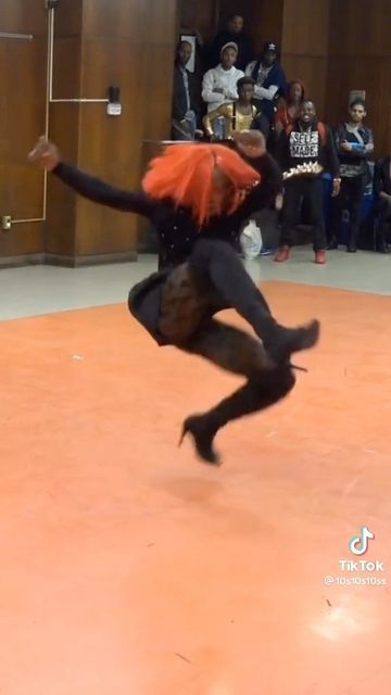 a person jumping in the air while wearing black clothing