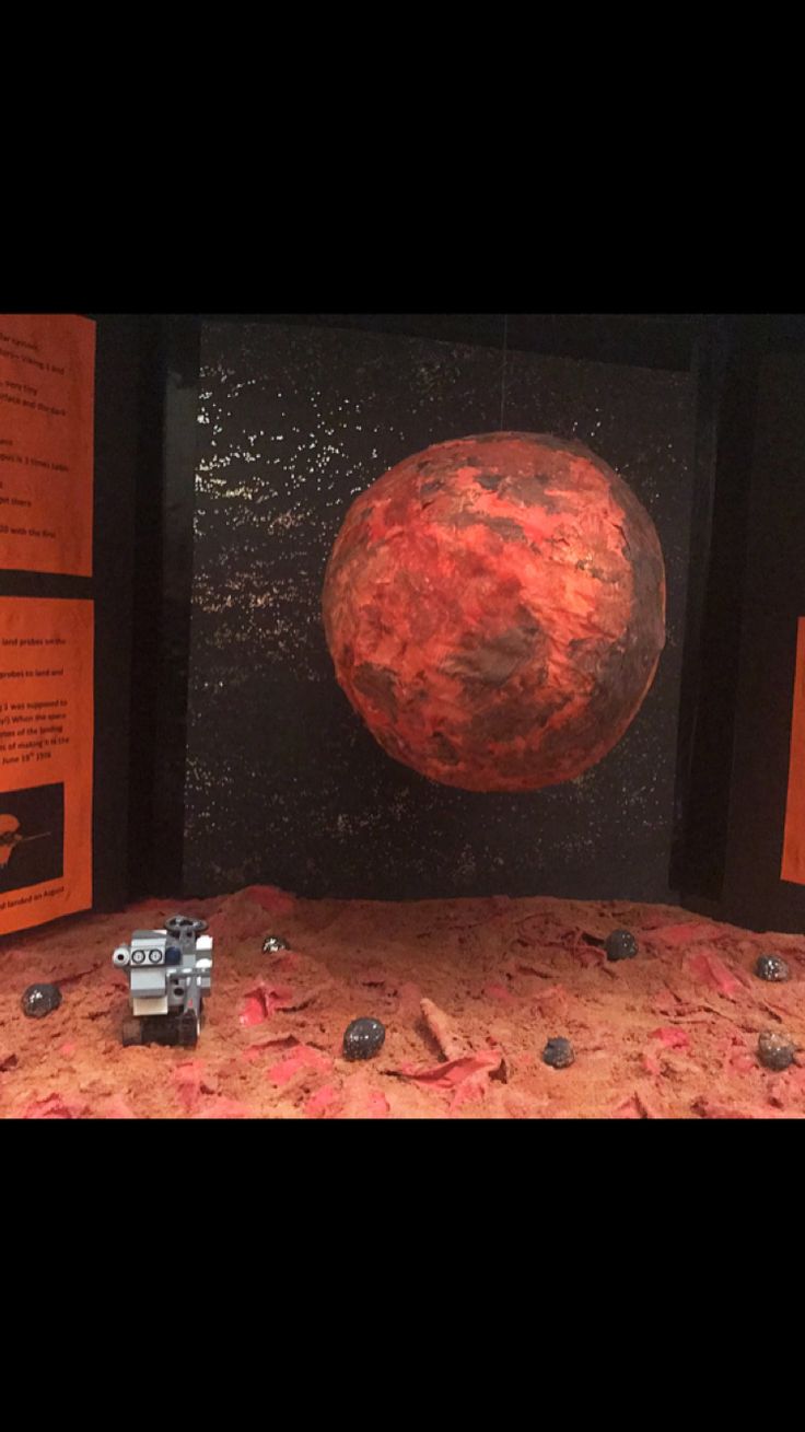 an image of a red planet in the middle of some sort of museum display with information about it