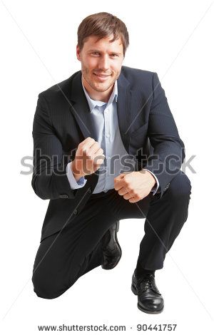 a man in a suit and tie posing for the camera with his hands on his hips