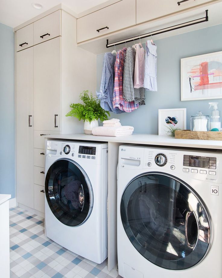 a washer and dryer in a laundry room with checkered tile flooring