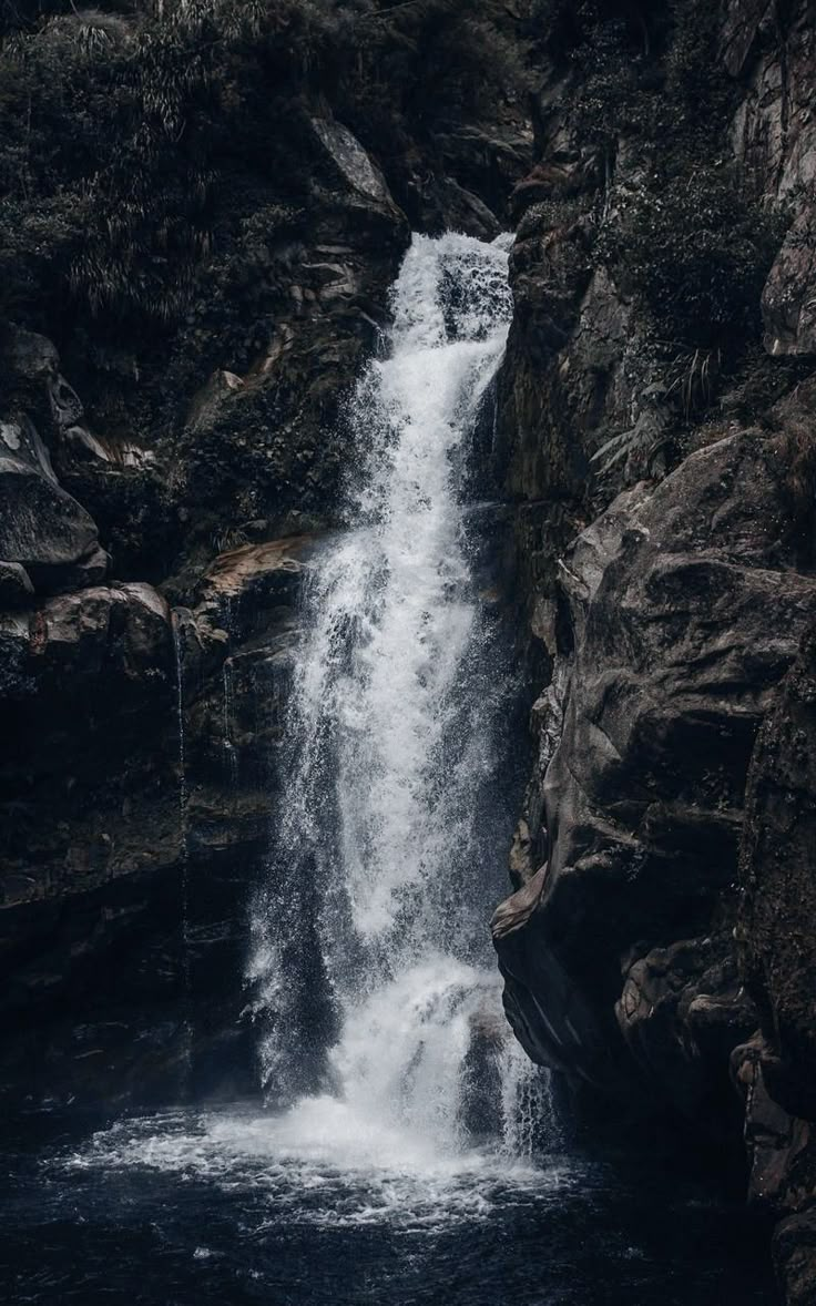 a waterfall with water cascading down it's sides