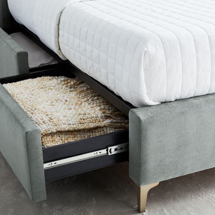 a bed with an ottoman underneath it and a mattress on the bottom shelf next to it