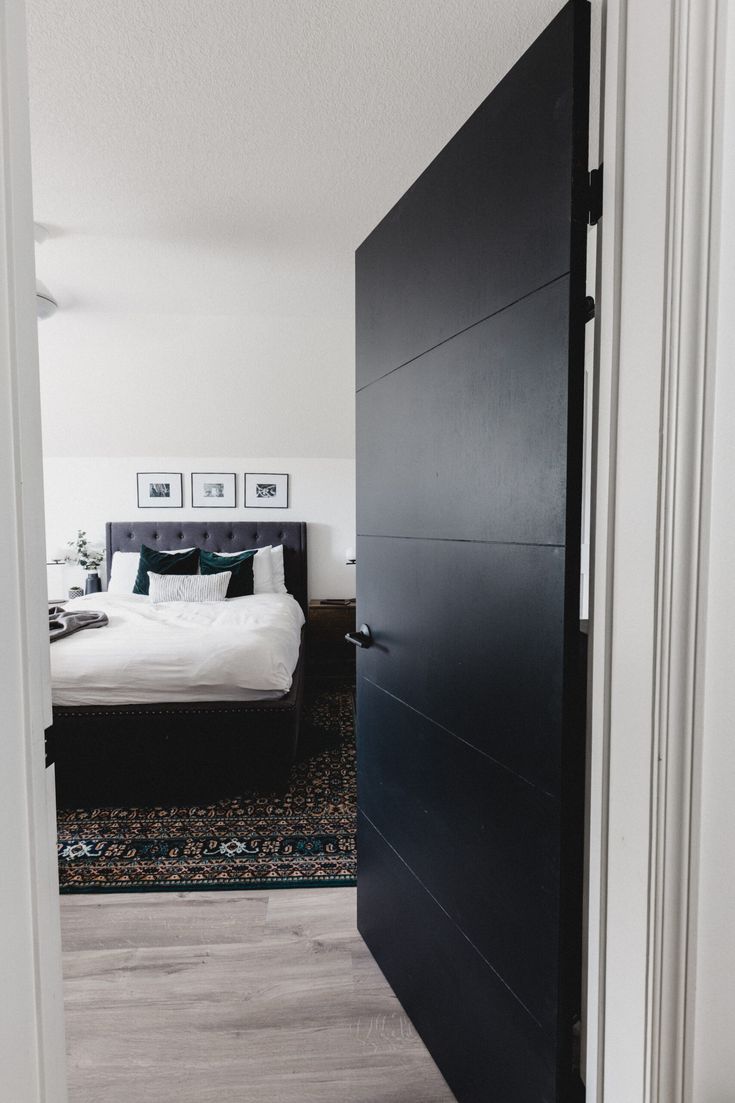 an open door leading to a bedroom with a bed