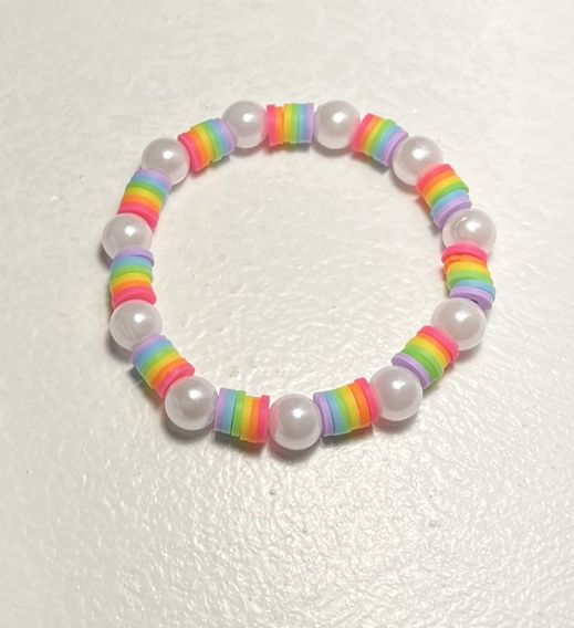 a bracelet with white beads and multicolored plastic beads