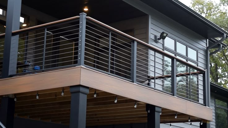 a house with metal balconies and wood railings