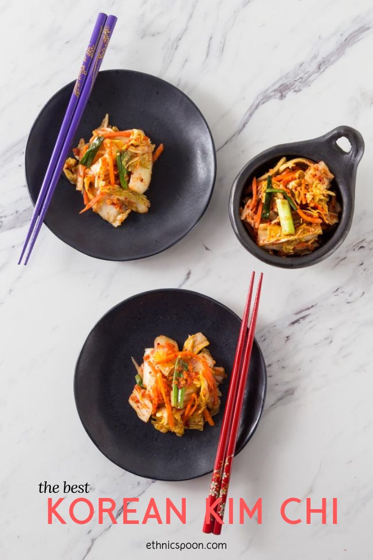 two black plates topped with food next to chopsticks